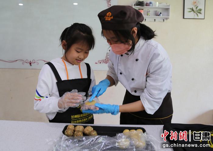 圖為在甘臺(tái)胞小朋友在工作人員指導(dǎo)下制作月餅。九美旦增 攝
